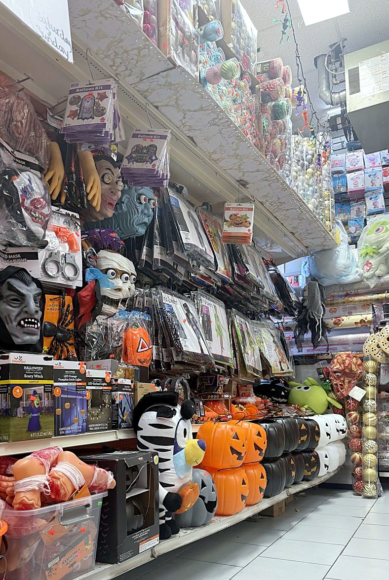 Halloween aisle with masks, costumes and pumpkin buckets